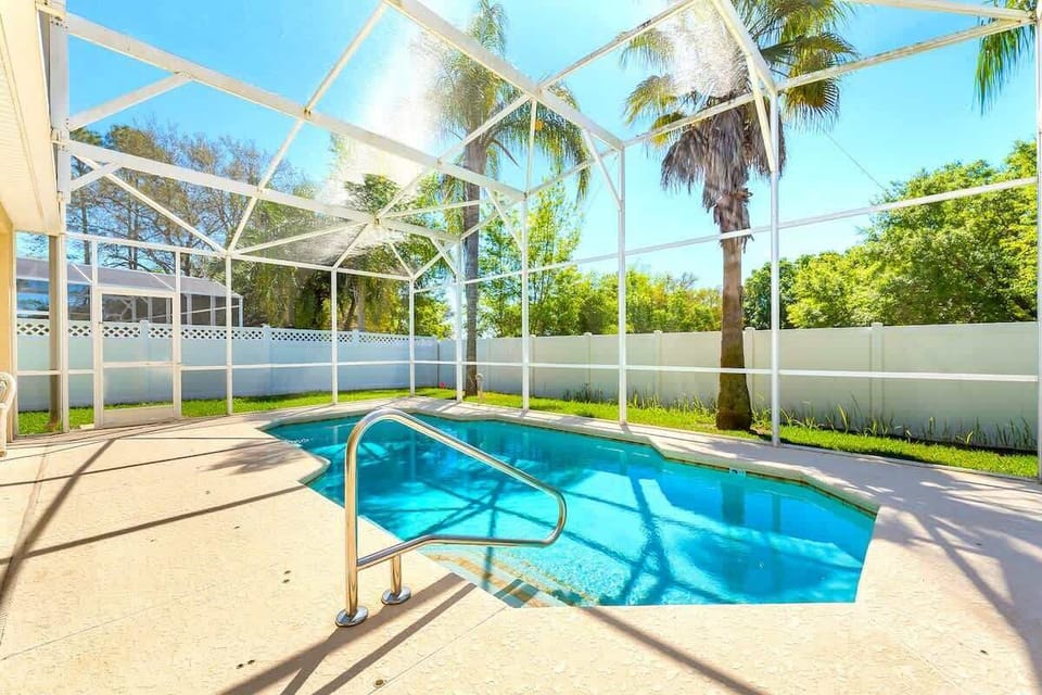 Sunshine and relaxation await! Dive into your private, screened pool, perfect for cooling off after a day exploring nearby attractions or just soaking up the Florida sun in complete privacy.