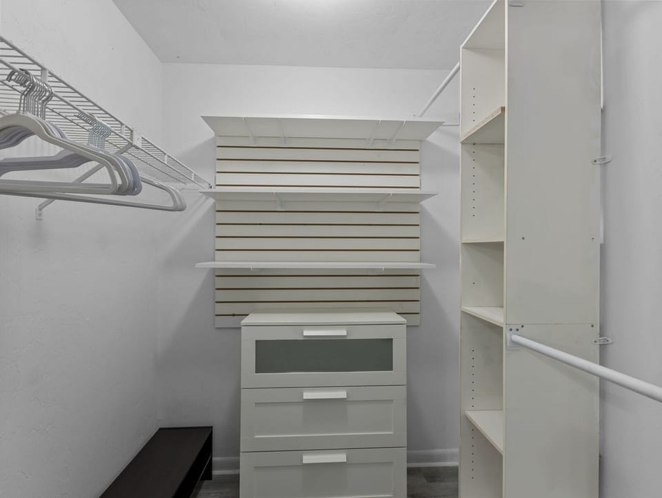 Walk in closet with hangers, drawers and shoe rack for longshort stays