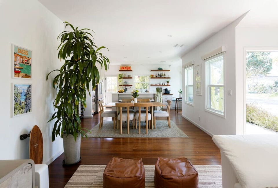 An open-concept space drenched in natural light, where warmth meets modern elegance—perfect for gathering, dining, and unwinding.