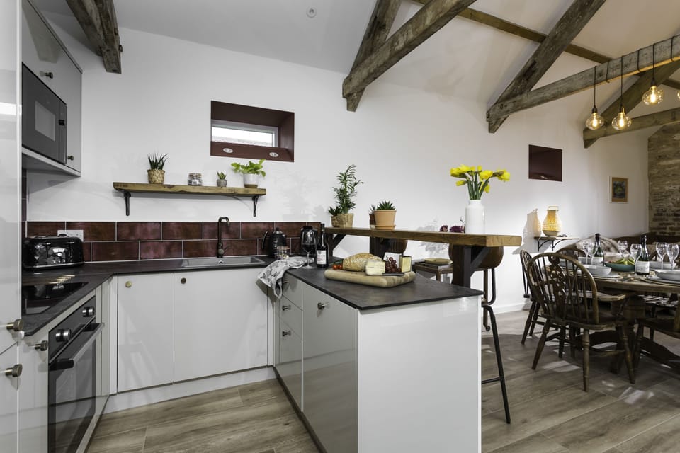 Well-equipped kitchen with an electric oven, dishwasher and coffee machine