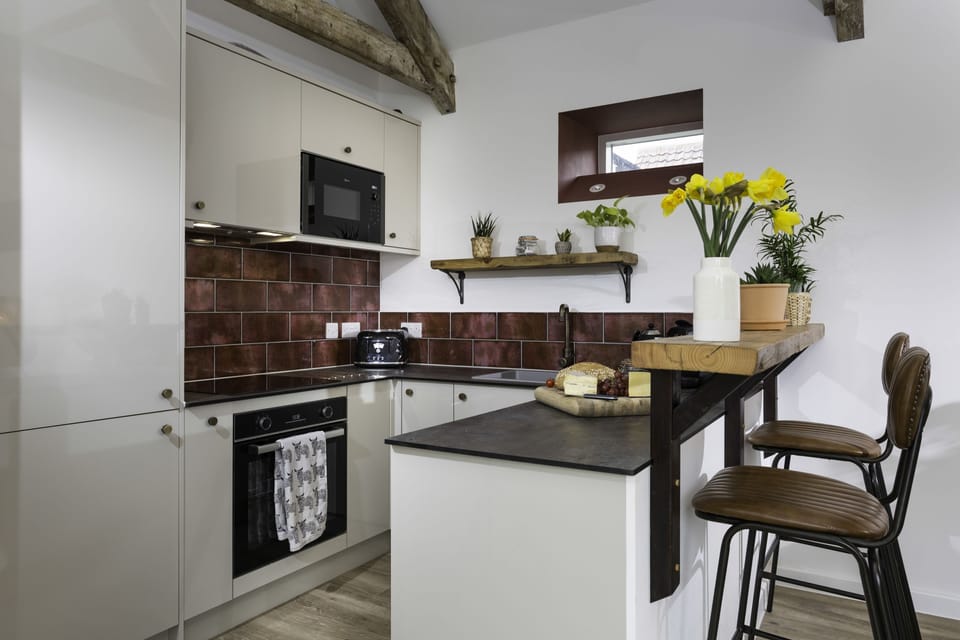 Kitchen area with a sit-up island seating two guests