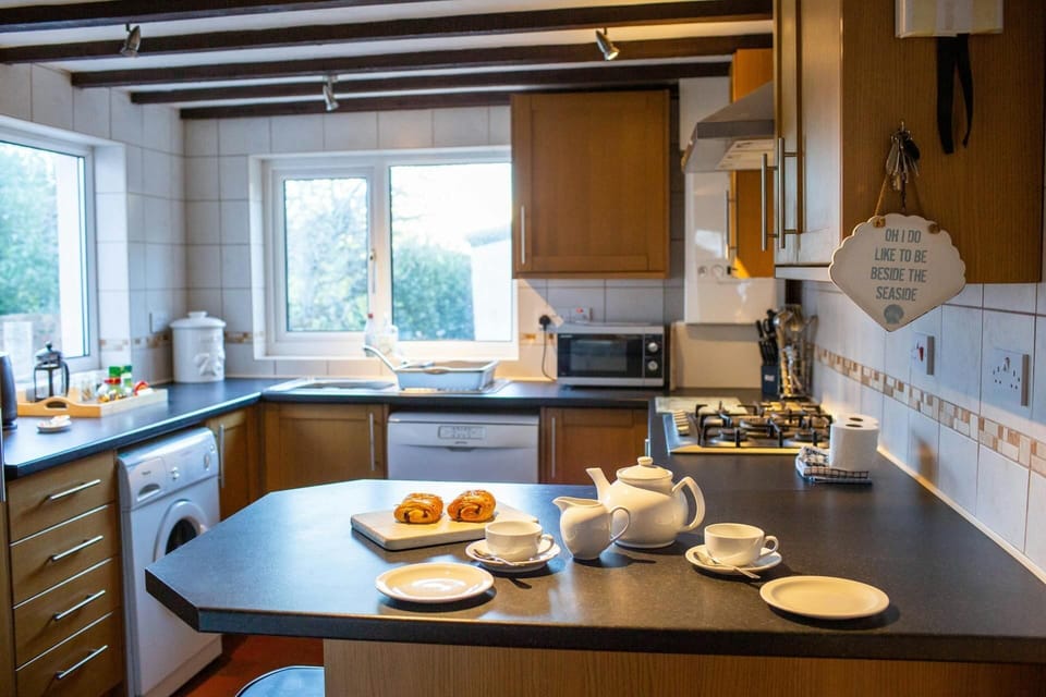 Wooden wall and base units. Breakfast bar laid for breakfast