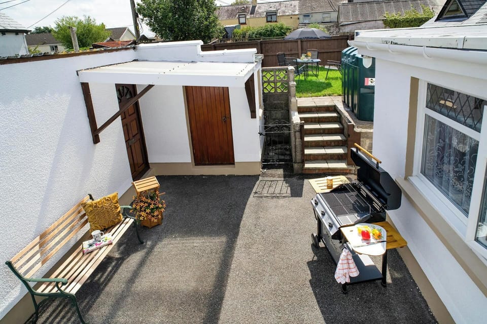 Patio area with barbecue, picnic bench and small covered area