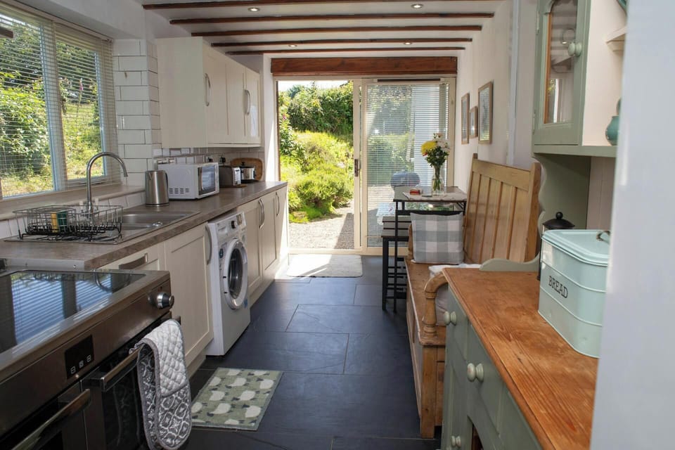 Kitchen with range cooker, washing machine and microwave