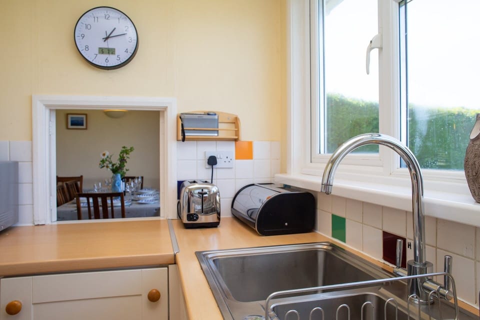 Kitchen with toaster and hatch leading to the dining area
