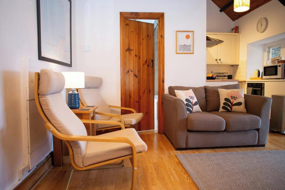 Lounge with armchairs, sofa, view of kitchen