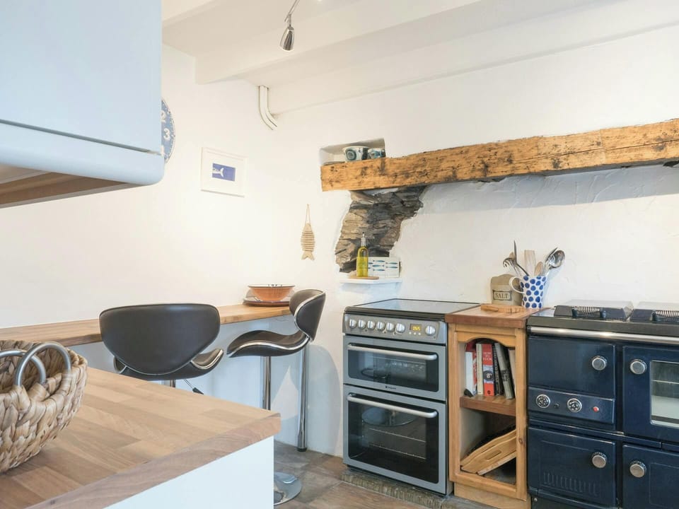 Kitchen with cooker and range, wooden beam, breakfast bar