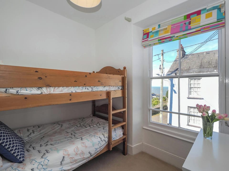 Bunkbeds, chest of drawers and distant sea views