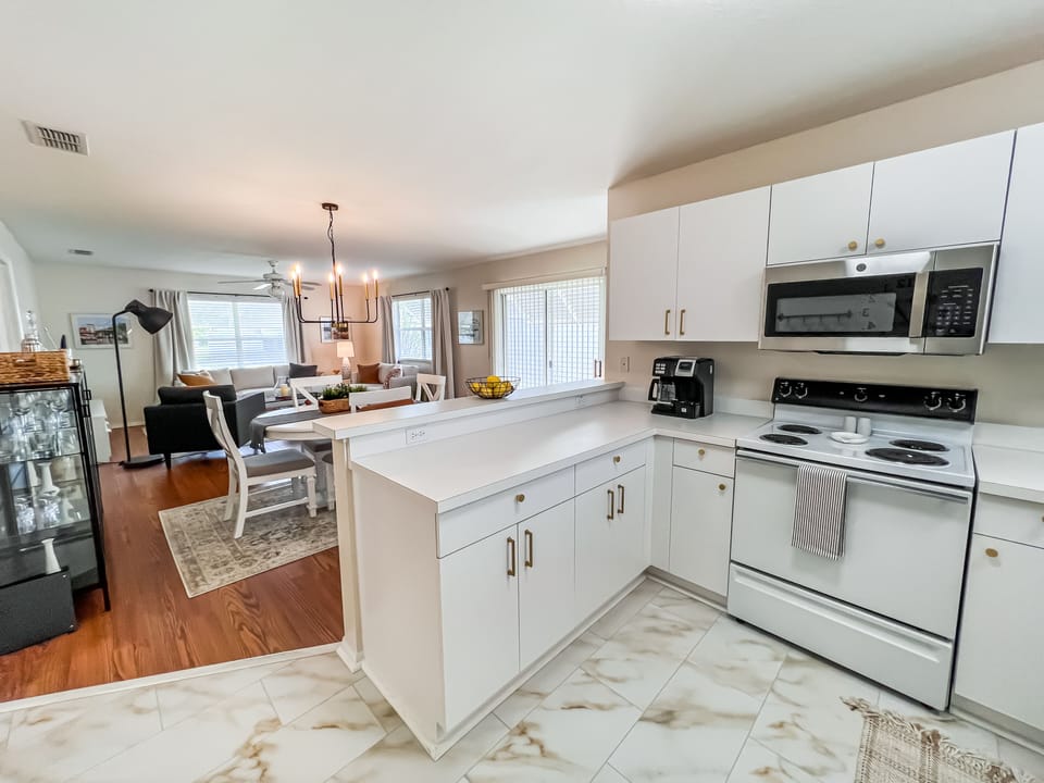 Open Kitchen with Breakfast Bar, overlooking Dining and Living Room.