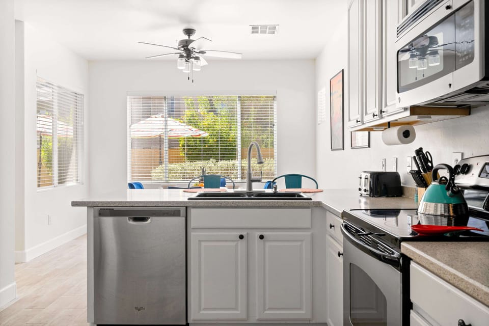 Kitchen with scenic view; prepare meals, enjoy nature beyond windows.