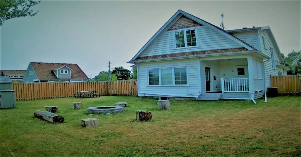 Private fenced backyard with firepit.
