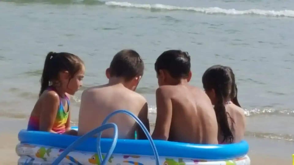 Kids playing on the beach.