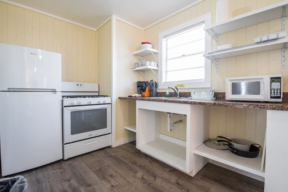 The kitchenette has a refrigerator, gas range, coffee maker, and microwave