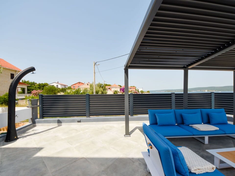 Sky, Plant, Shade, Outdoor Furniture, Leisure, Fence, Building, Urban Design, Roof, City