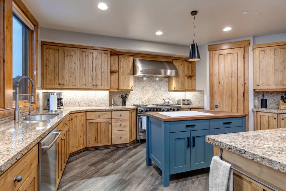A large kitchen with an island and stainless-steel appliances.
