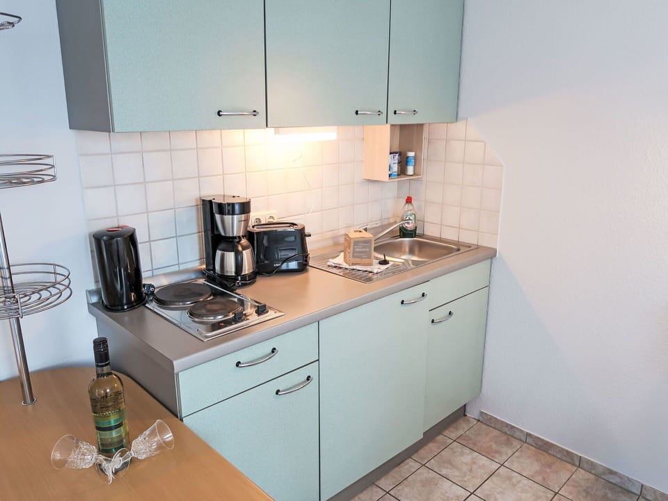 Cabinetry, Countertop, Kitchen Sink, Tap, Building, Sink, Kitchen Stove, Kitchen Appliance, Kitchen, Cooktop