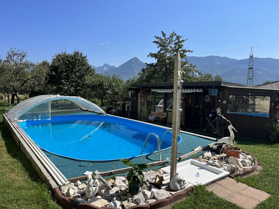 Water, Sky, Property, Swimming Pool, Shade, Mountain, Outdoor Furniture, Leisure, Urban Design, Landscape