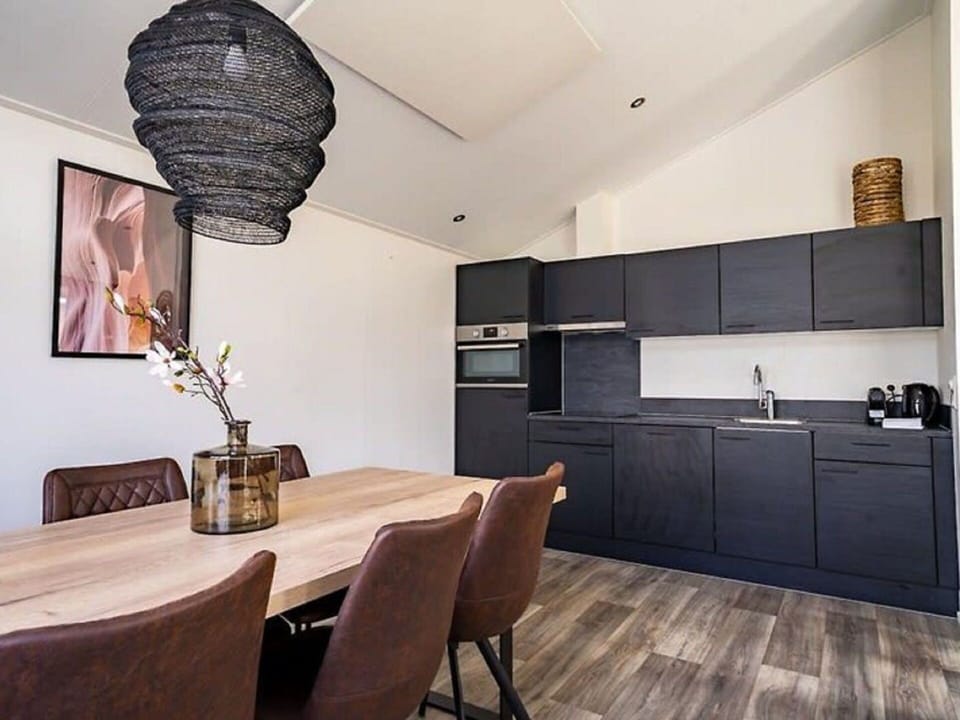 Furniture, Cabinetry, Table, Countertop, Wood, Picture Frame, Lighting, Interior Design, Chair, Flooring