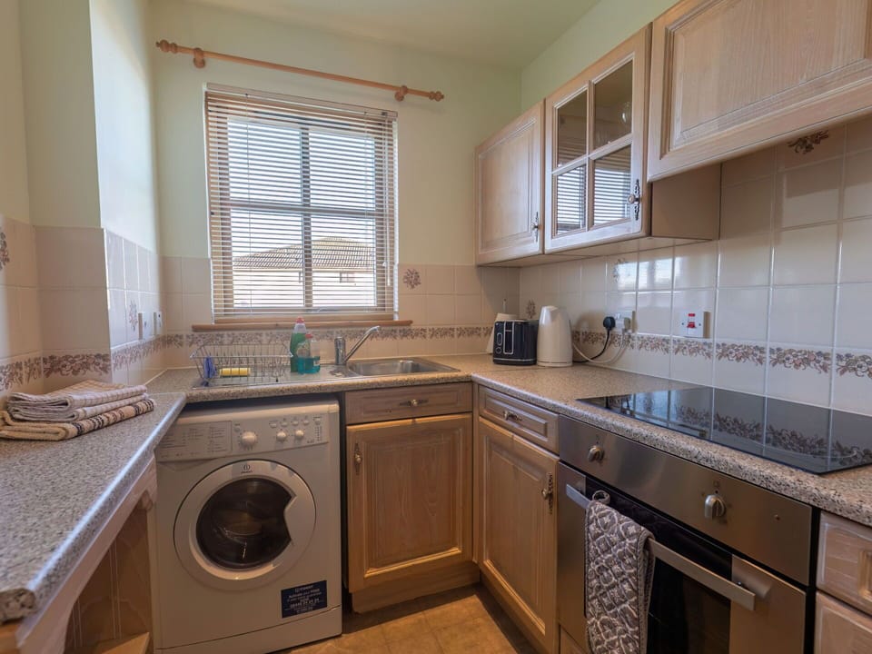 Laundry Room, Cabinetry, Property, Washing Machine, Kitchen Sink, Window, Sink, Countertop, Clothes Dryer, Kitchen Stove