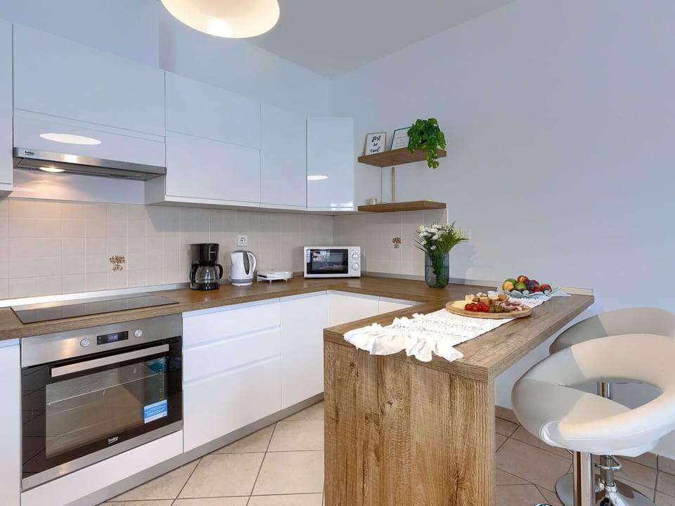 Cabinetry, Property, Countertop, Kitchen Stove, Building, Interior Design, Kitchen Appliance, Kitchen, Wood, Flooring