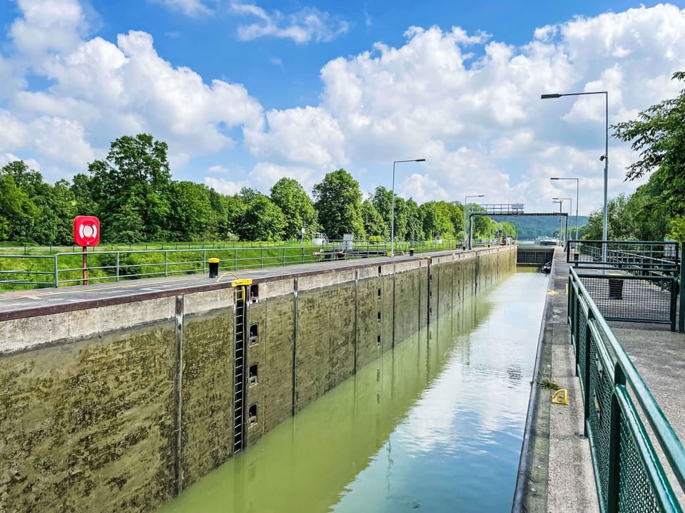 Cloud, Sky, Water, Street Light, Infrastructure, Tree, Body Of Water, Watercourse, Bank, Fence