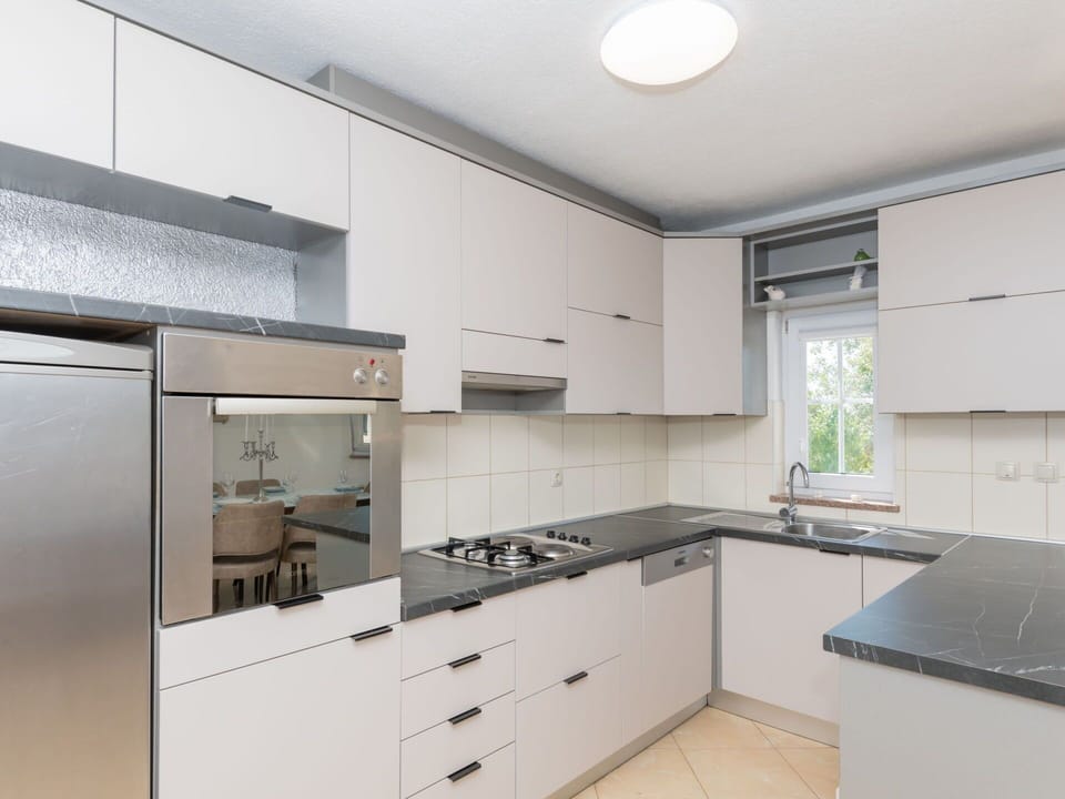 Kitchen, Countertop, Kitchen Appliance, Cabinetry, Major Appliance, Kitchen Stove, Interior Design, Flooring, Drawer, Stove