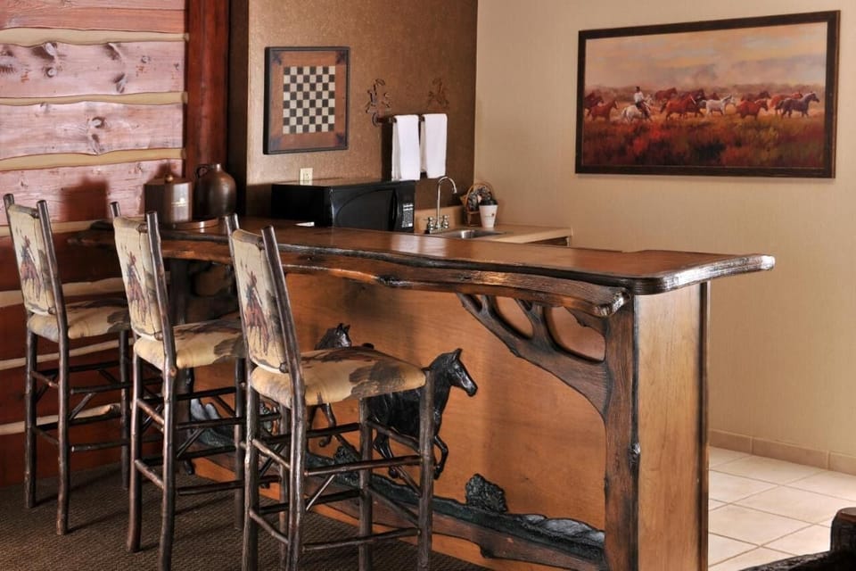Sip and linger at handcrafted bar seating with Western flair.
