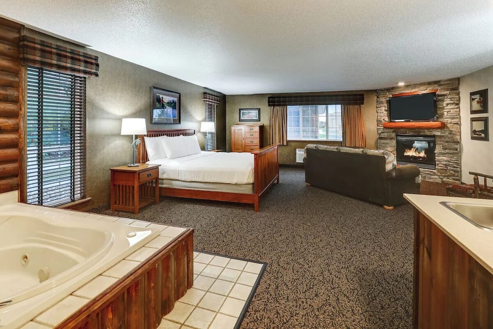 Sink into plush bedding beside a cozy stone fireplace.