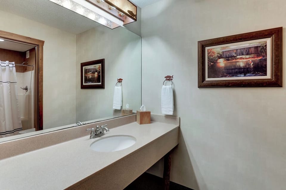 Freshen up with a bright vanity and generous mirror space.