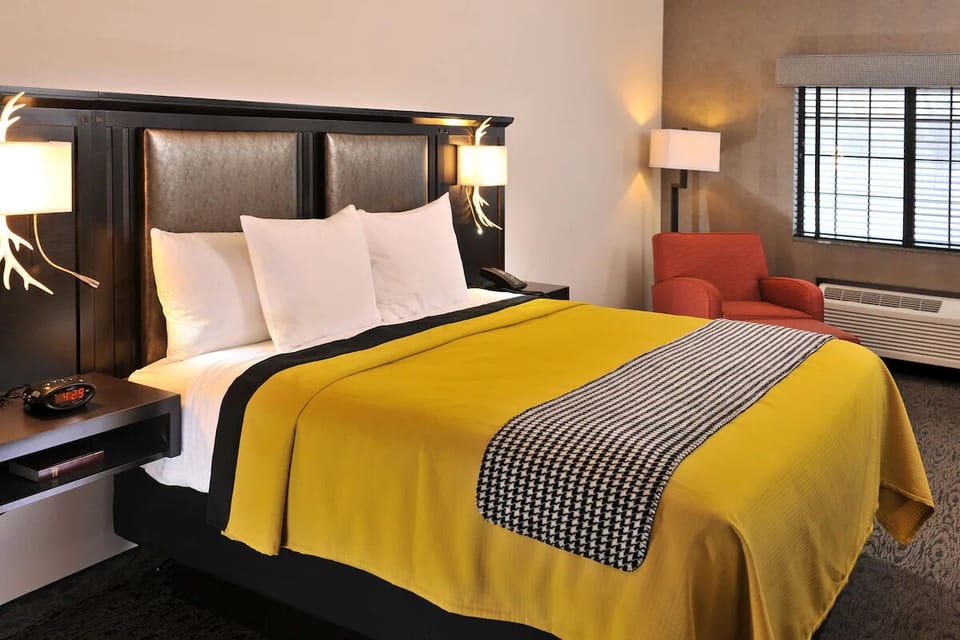 Drift off in crisp linens under cozy bedside glow.