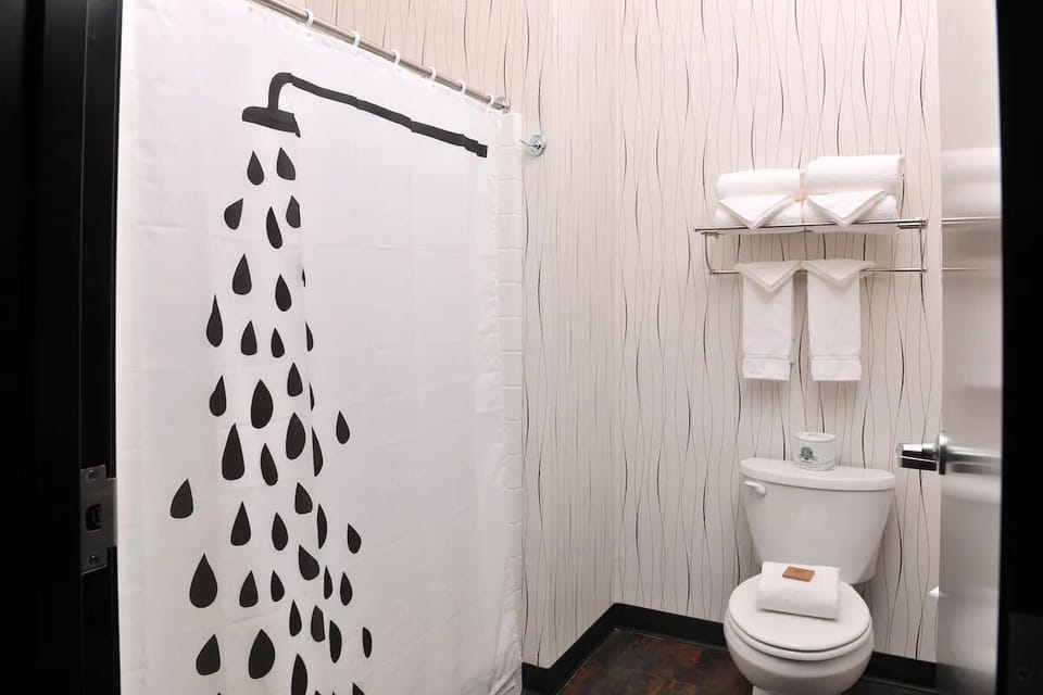 Rinse off in a simple, spotless shower-and-bath setup.