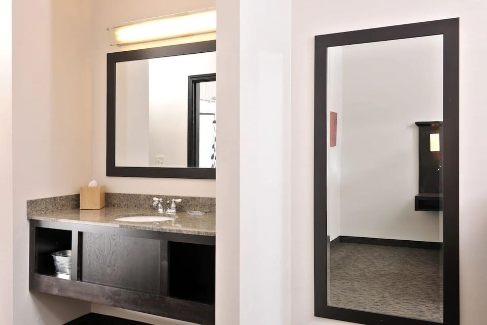 Freshen up at a spacious vanity with bright, clean lighting.
