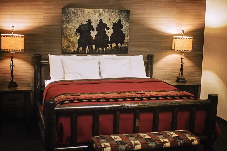 Relax in rustic comfort with glowing bedside lamps and art.