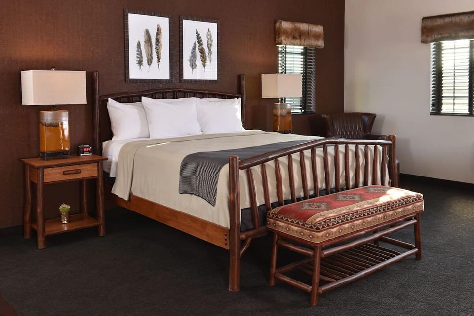 Unwind in a cozy log-frame bed with warm lodge style.
