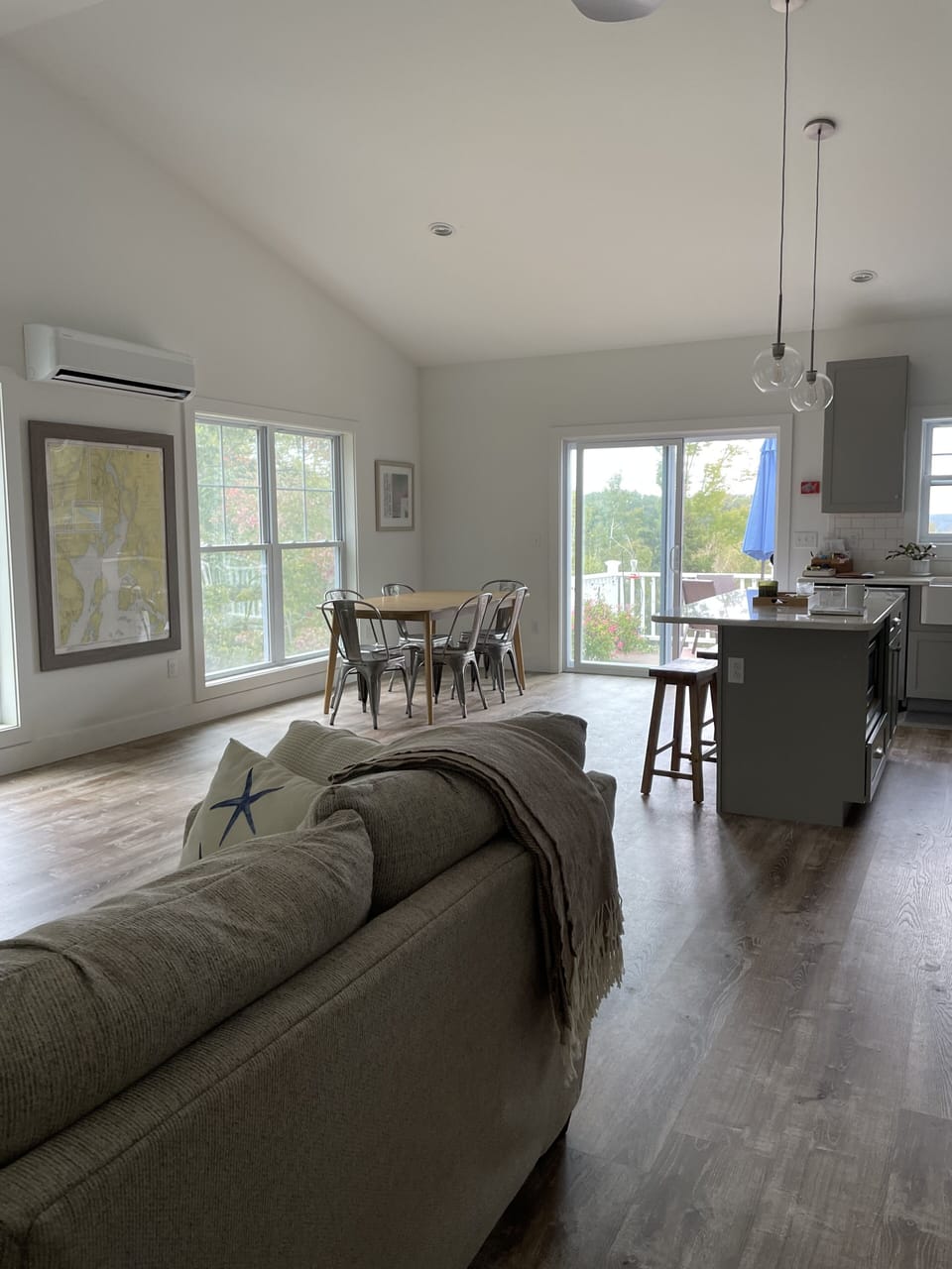 Great room, kitchen and dining space, with sliding doors to deck. 
