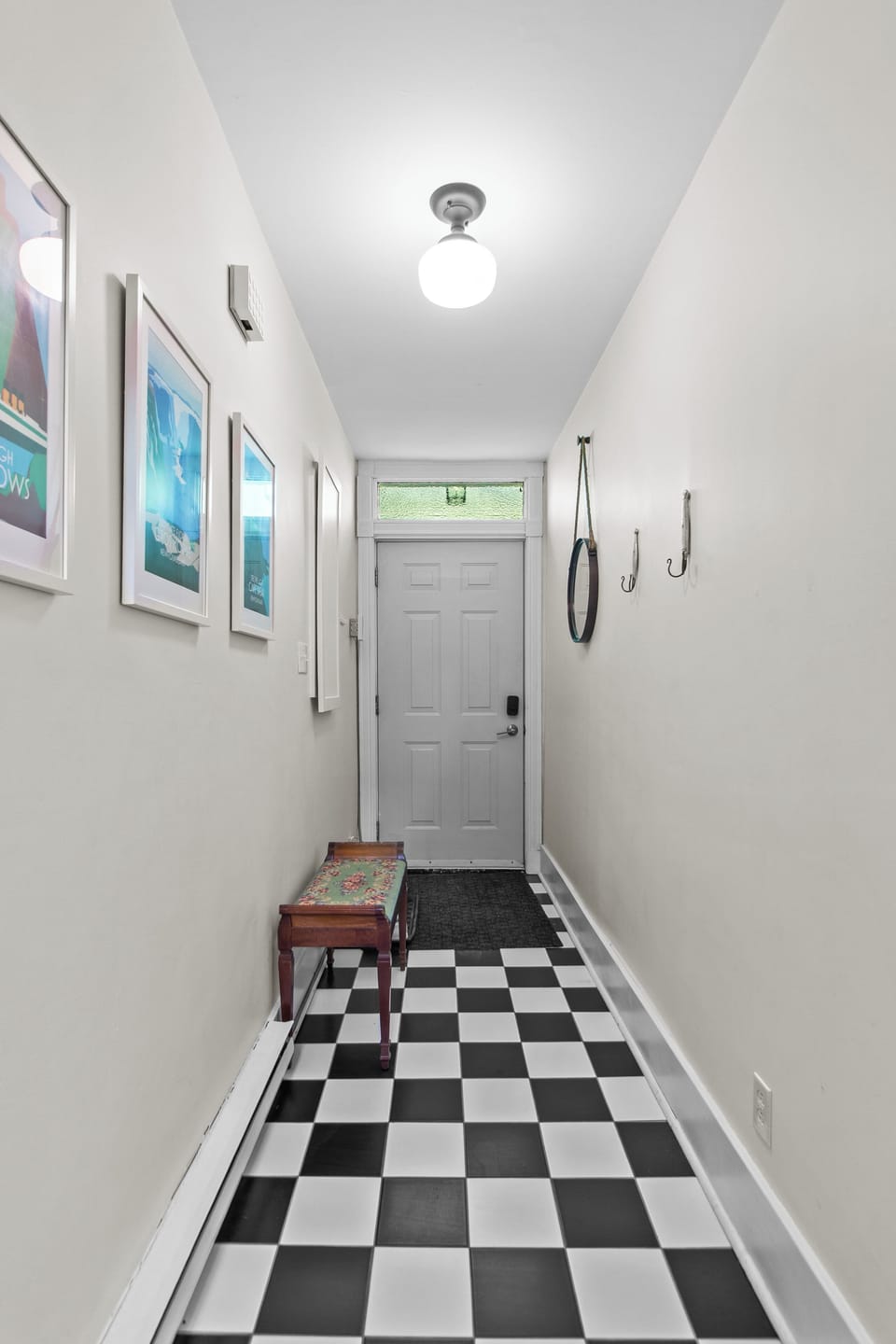 A spacious and functional entryway with a bench and hooks for your coats and bags.