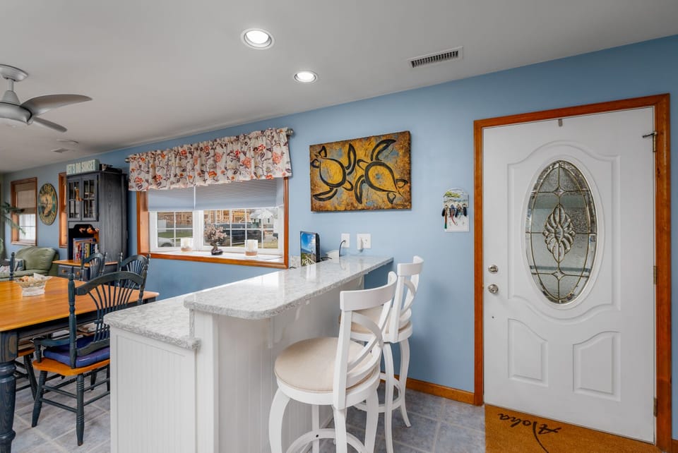 Quartz countertop with bar stools.