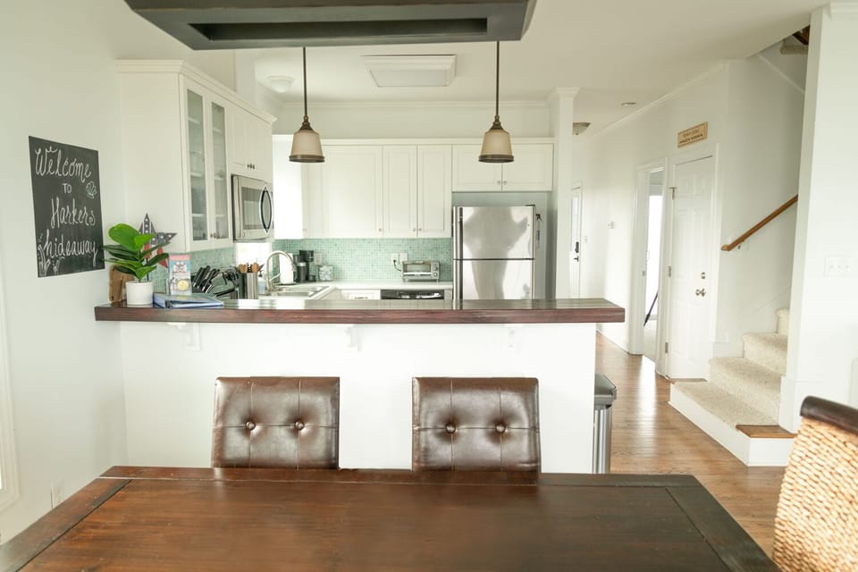 Dining table, bar, and open kitchen layout