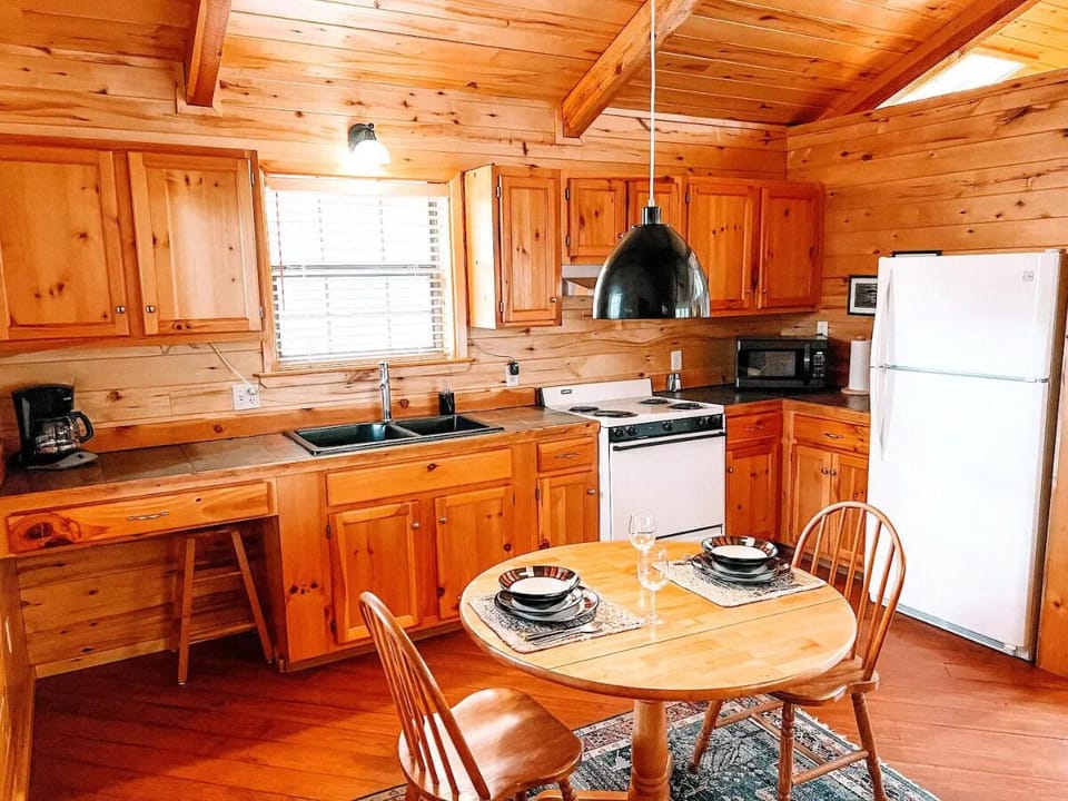 Cook your favorite meals in the fully equipped kitchen, complete with modern appliances, a coffee maker, microwave, and ample counter space. The adjacent dining area offers a cozy spot for enj