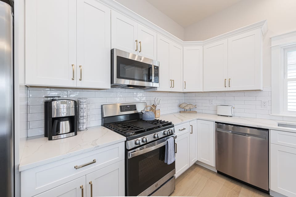 Modern White Kitchen with Stainless Steel Appliances