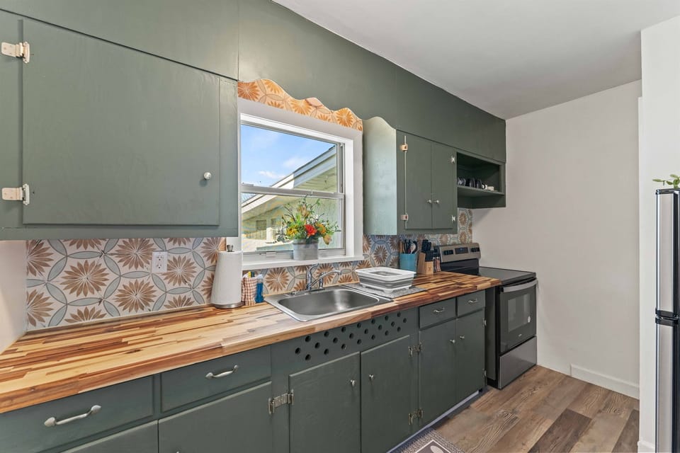 Kitchen window offering views of the trees and river, bringing natural light into the space.