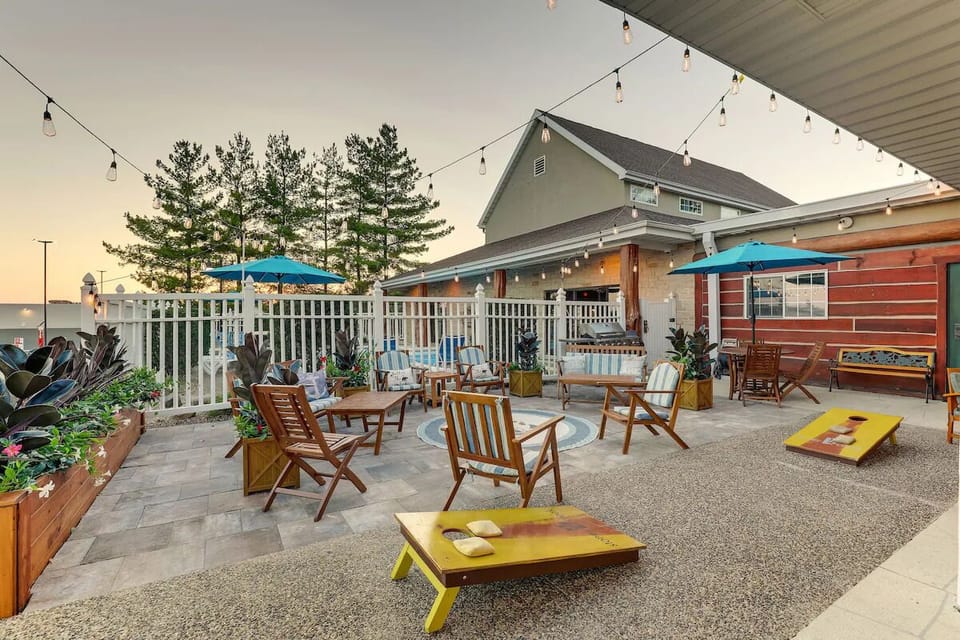 Linger outside under café lights with games and seating.