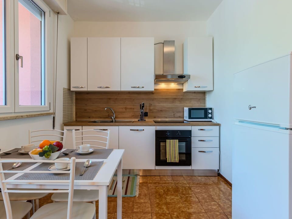Furniture, Kitchen Appliance, Kitchen, Interior Design, Countertop, Flooring, Major Appliance, Floor, Cabinetry, Wood