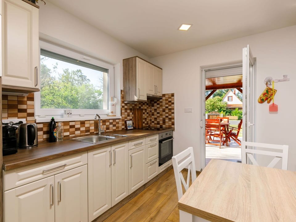 Cabinetry, Furniture, Countertop, Window, Wood, Flooring, Kitchen, Floor, Wood Stain, Drawer
