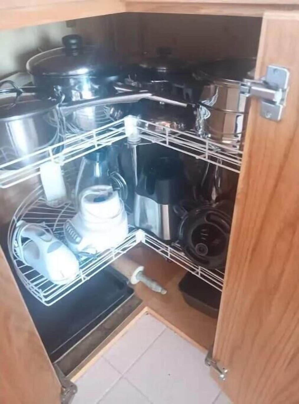 Pots and pans on top, tools with cords on the bottom.