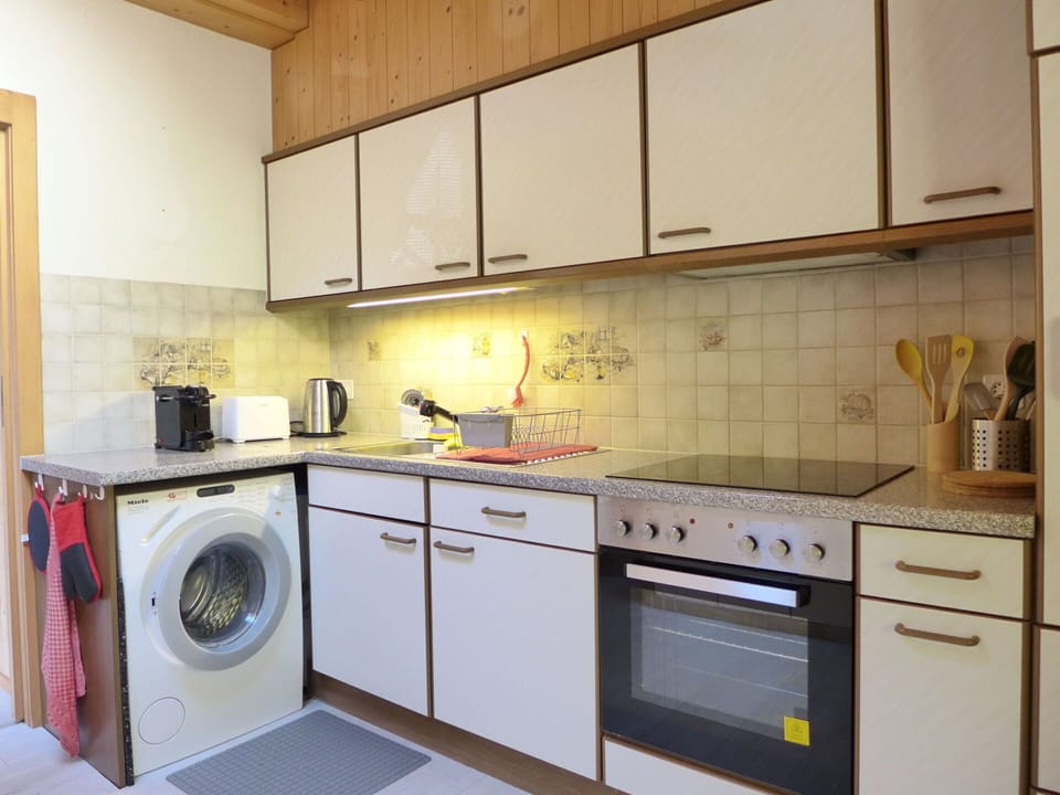Cabinetry, Countertop, Kitchen, Kitchen Stove, Kitchen Appliance, Home Appliance, Laundry Room, Cooktop, Washing Machine, Lighting