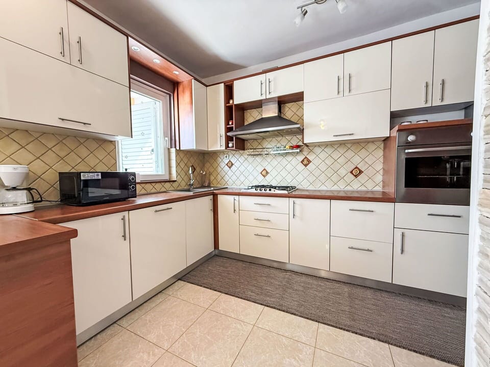 Kitchen, Countertop, Cabinetry, Kitchen Appliance, Major Appliance, Flooring, Wood, Interior Design, Drawer, Floor