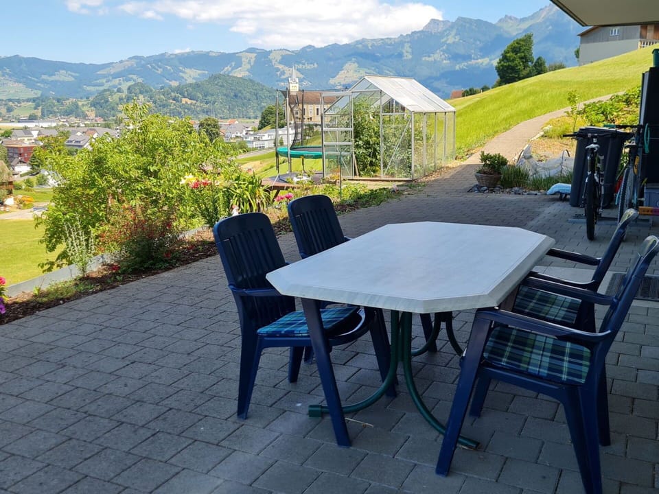 Plant, Sky, Table, Cloud, Furniture, Property, Flowerpot, Chair, Mountain, Azure
