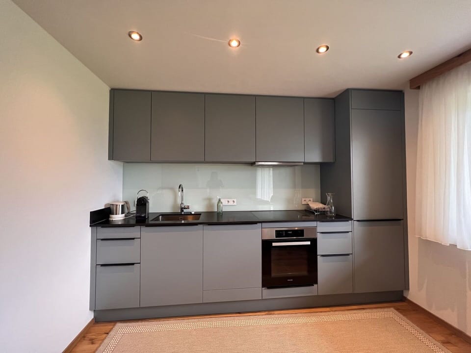 Cabinetry, Countertop, Property, Sink, Kitchen, Wood, Building, Flooring, Floor, Curtain