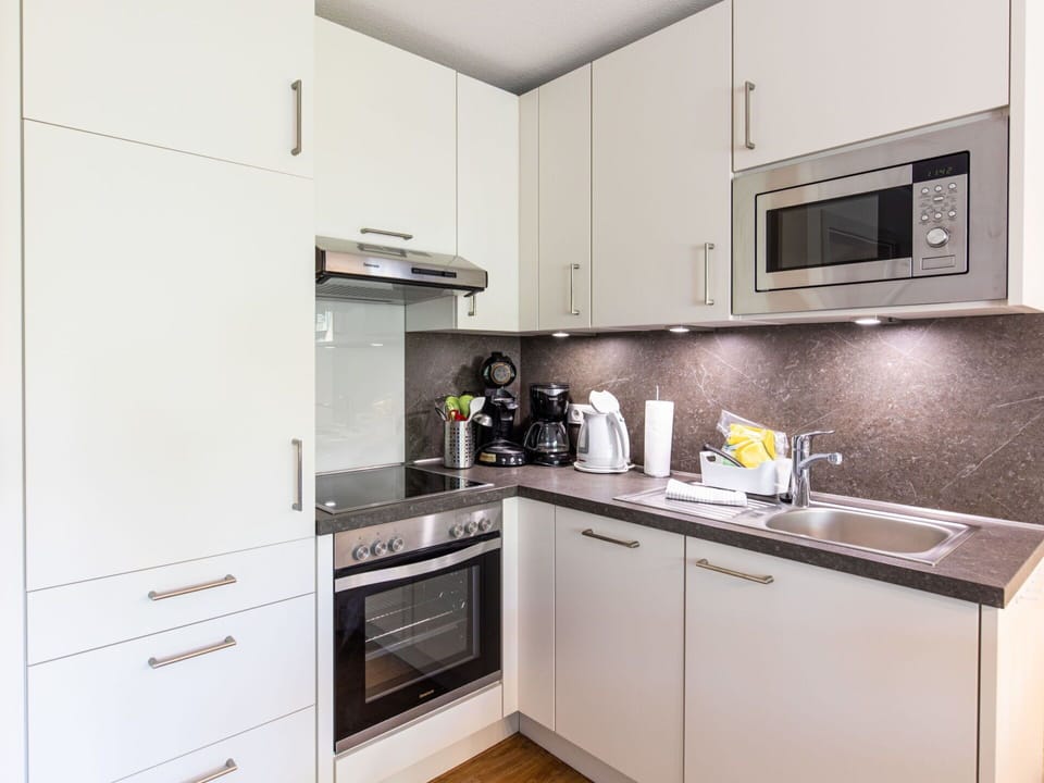 Cabinetry, Property, Countertop, Kitchen Sink, Sink, Kitchen Stove, Kitchen Appliance, Kitchen, Home Appliance, Building